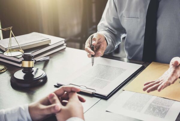 Legal Professional Insurance - Close-up of Businessman and Lawyer Having a Meeting in the Office With Law and Legal Services Concept