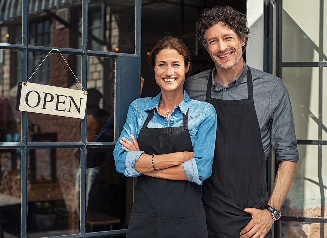 Business Insurance - Happy Businessman and Women Open Up Their Shop on a Sunny Day